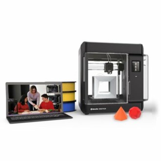 3D printer with laptop and students, filament spools, and printed shapes.
