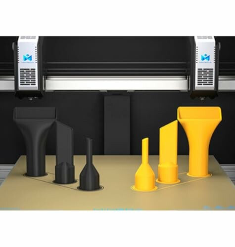 3D printer with black and yellow nozzles