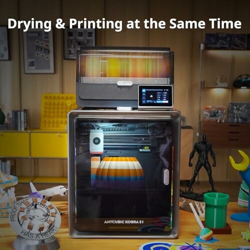 3D printer with integrated filament dryer in a workshop.
