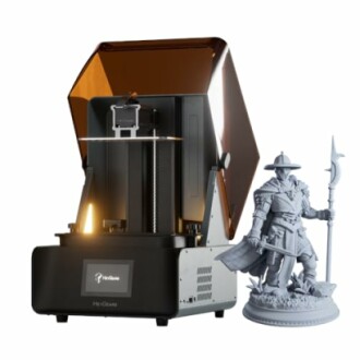 3D printer with a detailed figurine beside it.