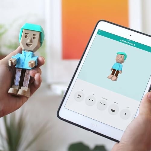 Person holding a toy and a tablet displaying a digital model of the toy.