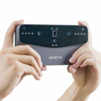 Hands holding an Einstar 3D scanner device.