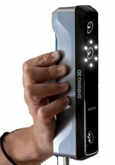 Hand holding a handheld 3D scanner with multiple cameras and lights.